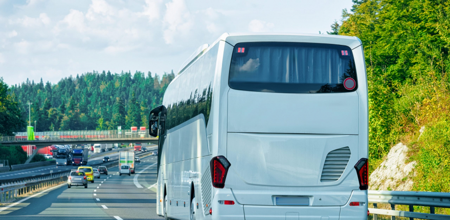 White Tourist bus in the road in Poland. Travel concept.